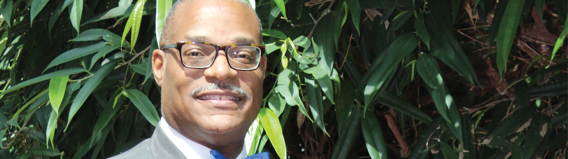 Photo of Dr. L. Marshall Washington smiling happily in the commons.
