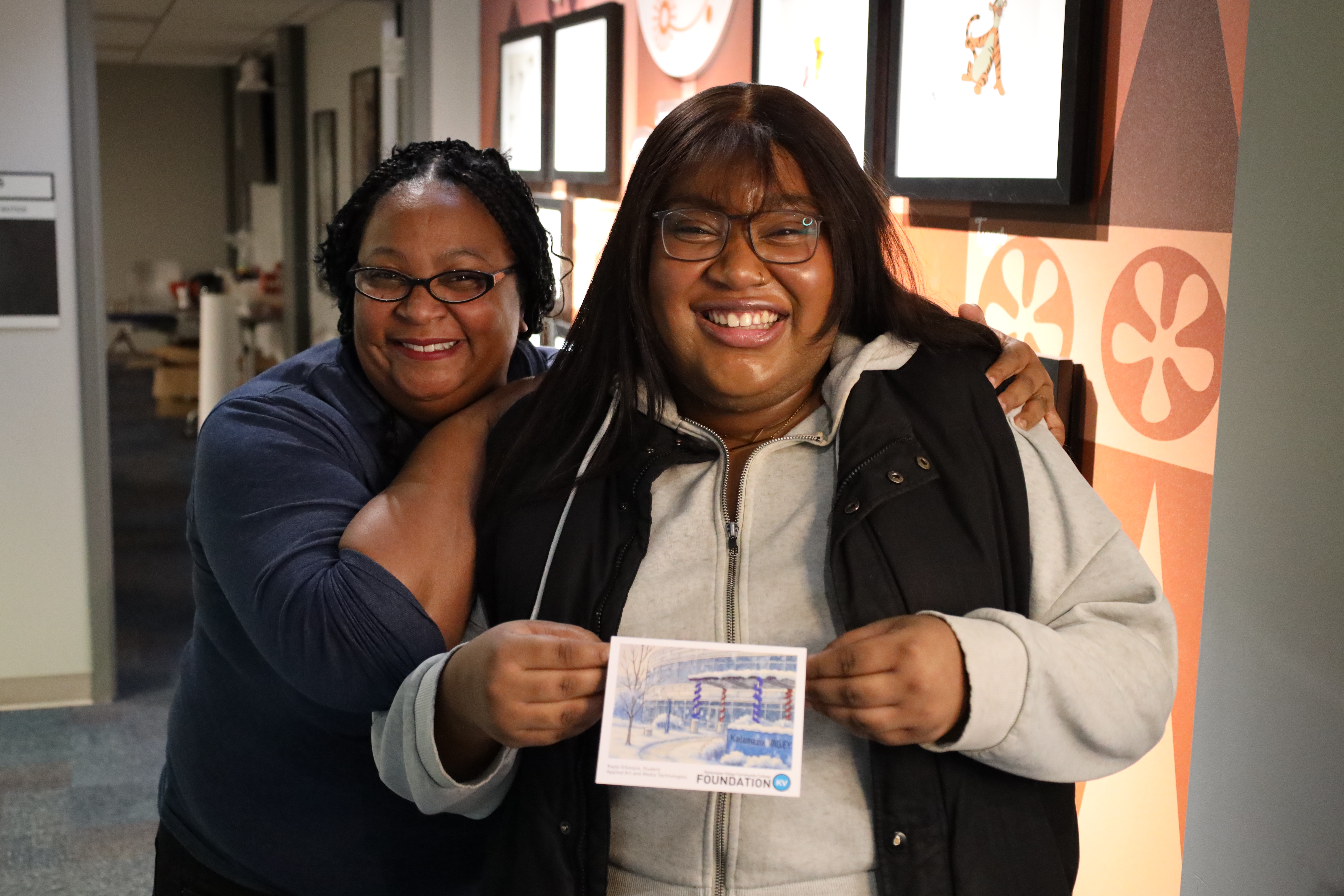 Whitchurch (left) poses at Valley’s Dec. 2025 commencement program Kayla Gillespie (front) holds the card she designed with Aubrey Rogers (back).