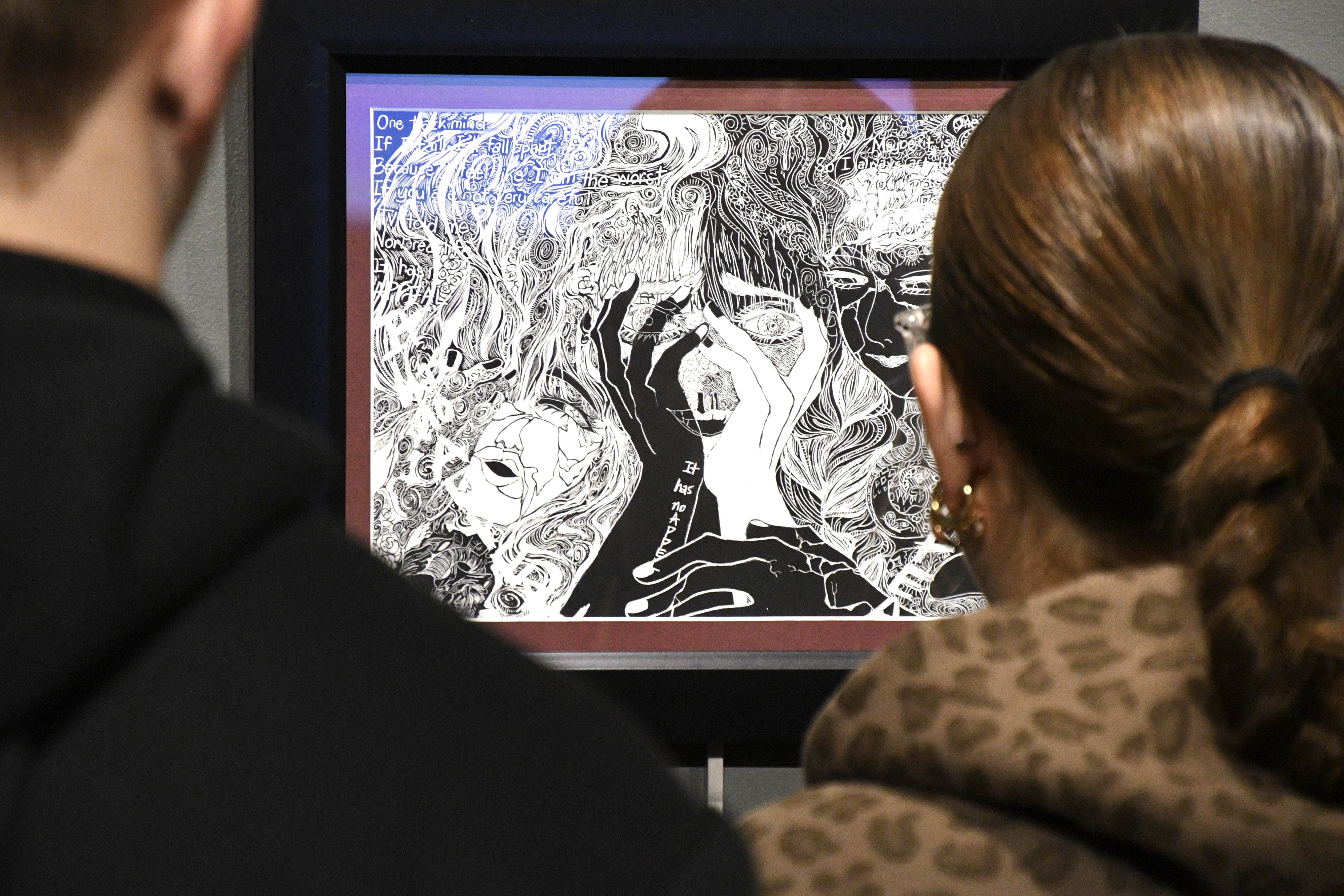Patrons of an art show observe an illustration.