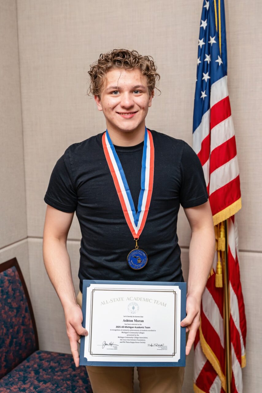 Photo of Ashton Moran holding the award