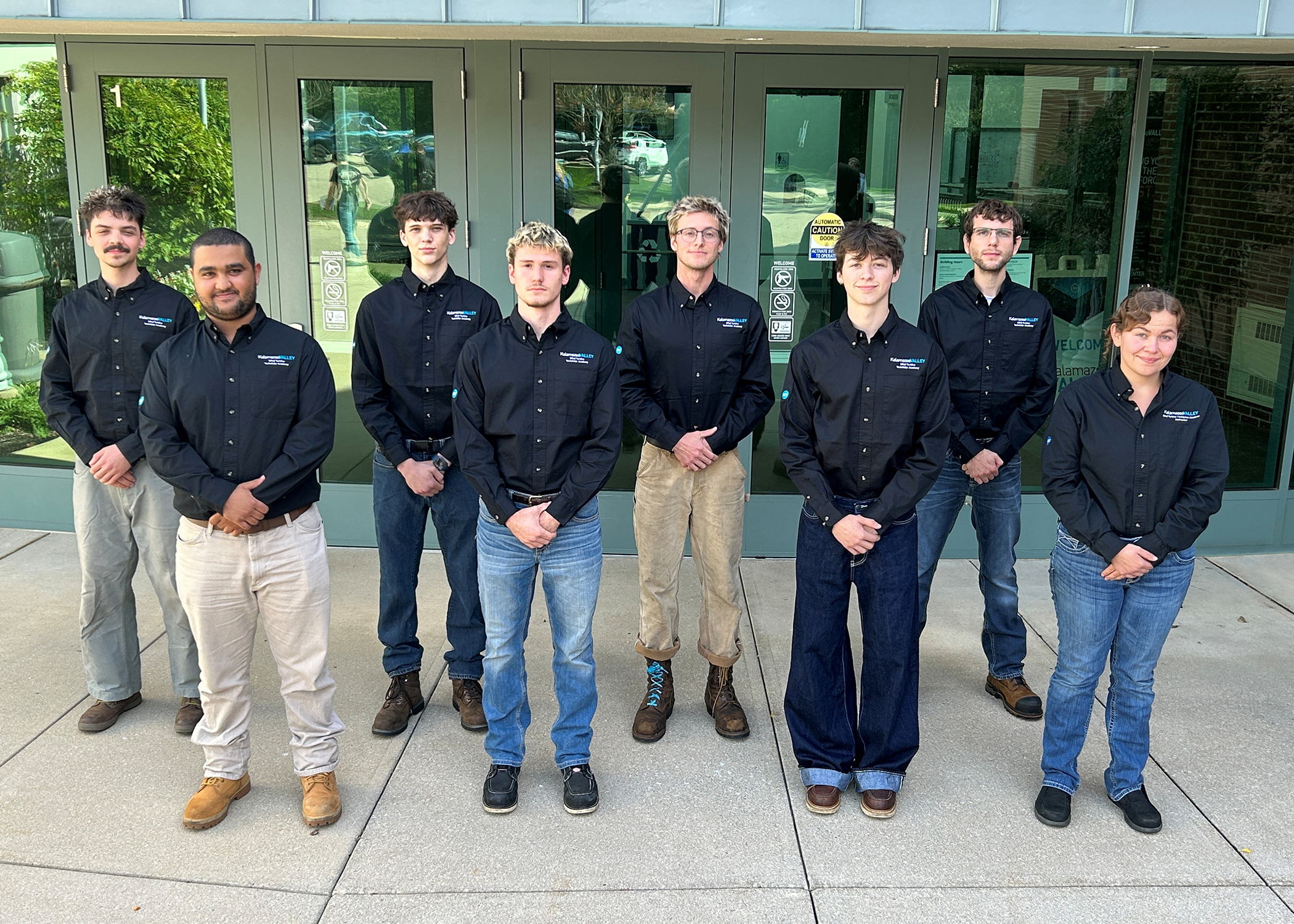 Kalamazoo Valley Community College's 32nd Wind Turbine Technician Academy standing alongside Instructional Manager Hannah Higgins.