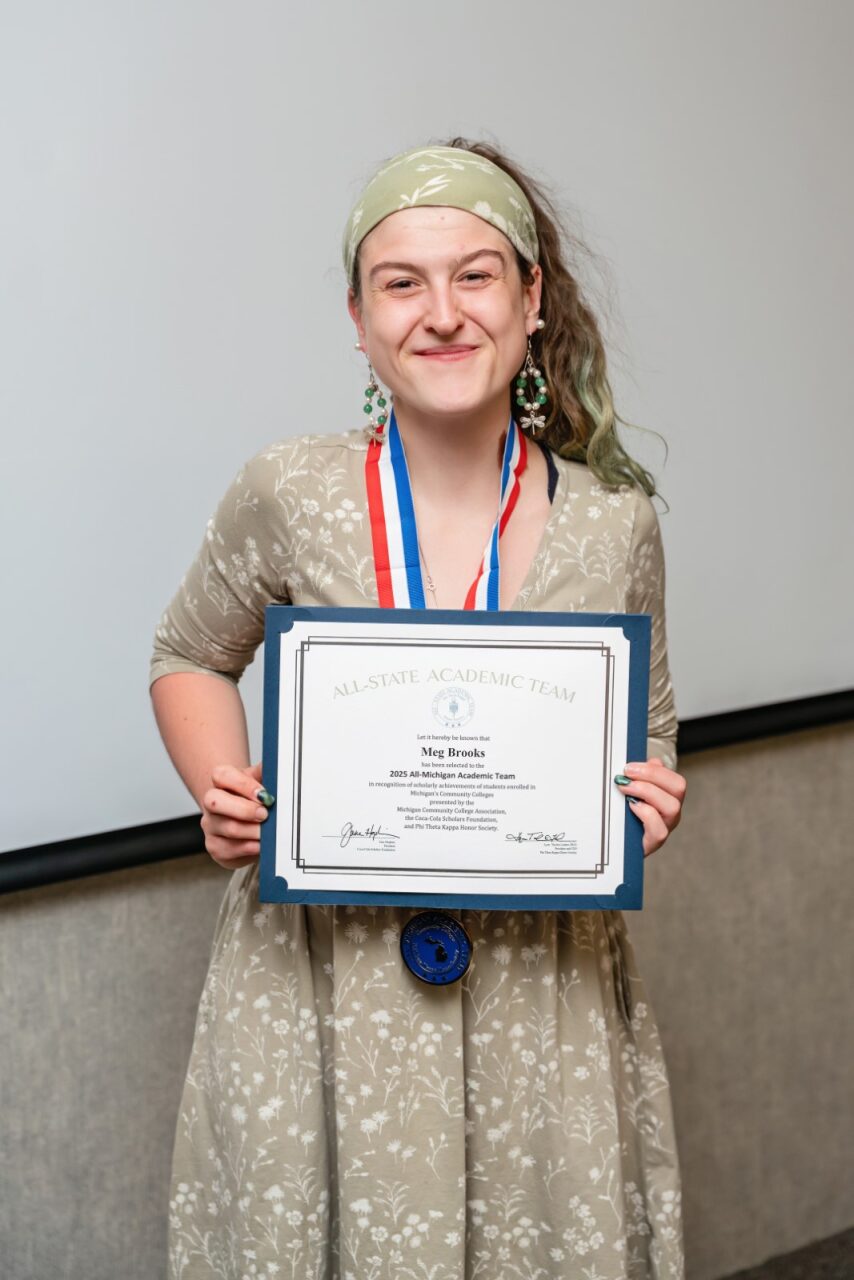 Photo of Meg Brooks holding the award