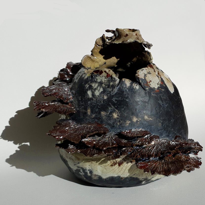 A ceramic orb with ceramic mushrooms jutting from it.