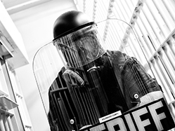 A police officer in riot gear.